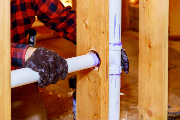 istock A plumber in plastic sewer pipe into putting glue on a pvc pipe 1290793667