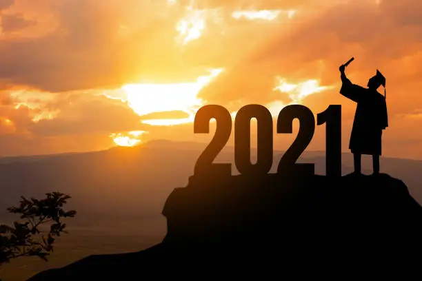 Photo of Silhouette Young man Graduation in 2021 years, education congratulation concept ,Freedom and Happy new year, copy space.