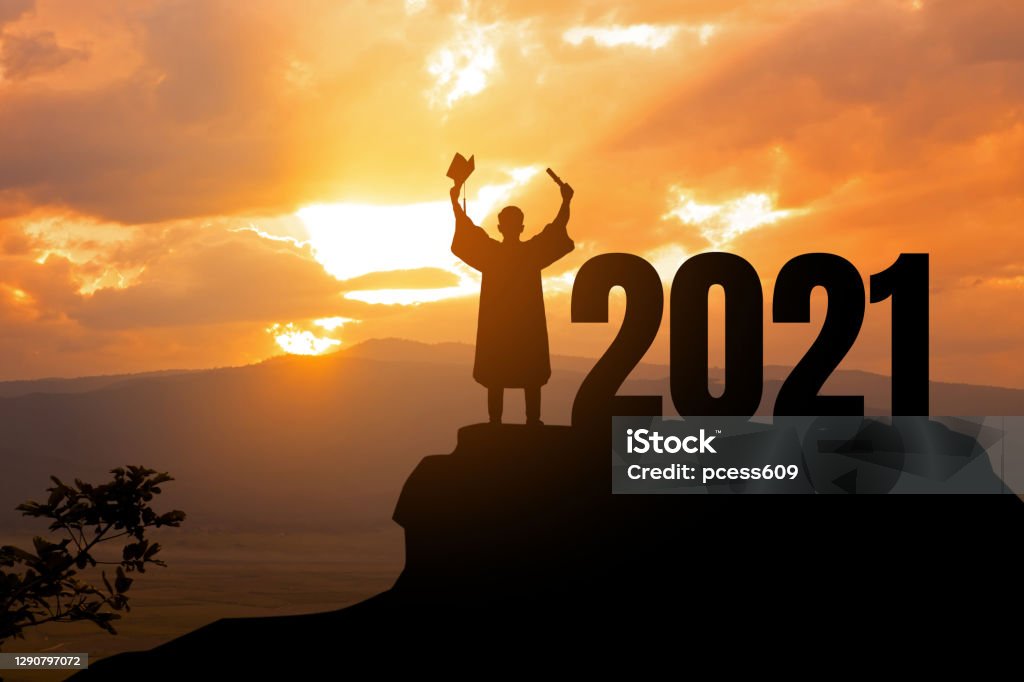 Silhouette Young man Graduation in 2021 years, education congratulation concept ,Freedom and Happy new year, copy space. Graduation Stock Photo