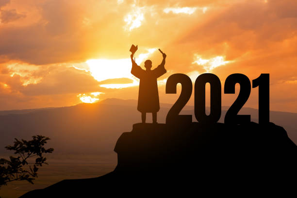 Silhouette Young man Graduation in 2021 years, education congratulation concept ,Freedom and Happy new year, copy space. Silhouette Young man Graduation in 2021 years, education congratulation concept ,Freedom and Happy new year, copy space. graduation photos stock pictures, royalty-free photos & images