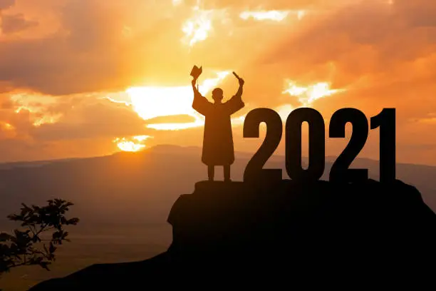 Photo of Silhouette Young man Graduation in 2021 years, education congratulation concept ,Freedom and Happy new year, copy space.