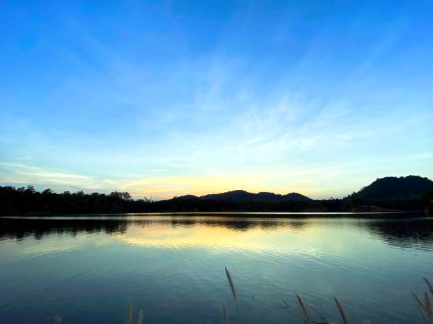 istock Panoramic view of mount against blue sky and lake 1290805659