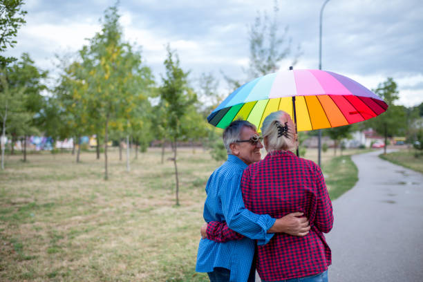 istock Couple walking in wet day 1290806378