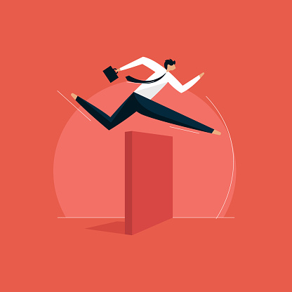 Businessman jumping over hurdle concept