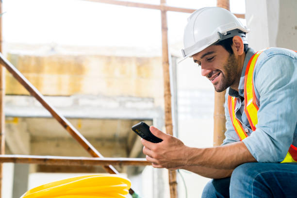 istock male caucasian smart engineering smile relax in site cnstruction with hand use smartphone relax after work 1290811040