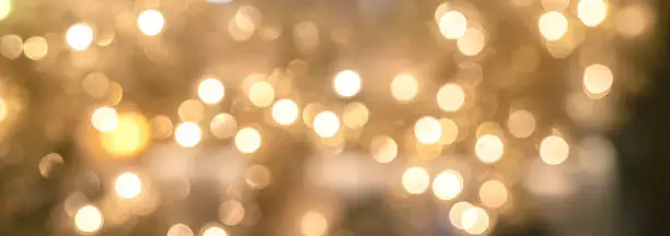 Photo of abstract blur golden glitter sparkle background festive background concept