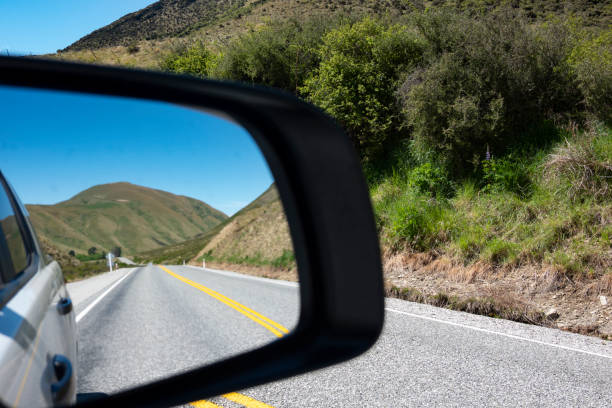 istock Lindis Pass highway and hills in rear vision mirror 1290814254