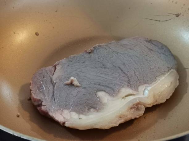 istock Steak is being roasted on the pan. 1290815195
