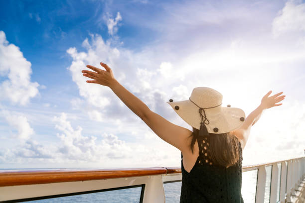 attractive carefree asian female woman casual cloth smile relax pleasure vacation time on cruise ship balcony with blue sky cloud background attractive carefree asian female woman casual cloth smile relax pleasure vacation time on cruise ship balcony with blue sky cloud background cruise ship people stock pictures, royalty-free photos & images