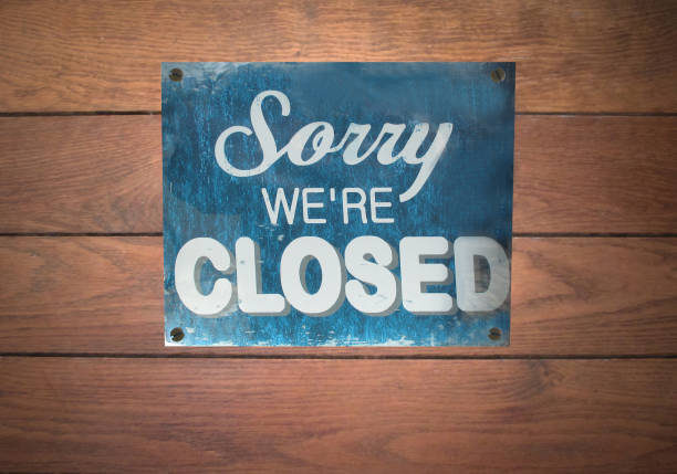 istock Sorry we're closed  Panel with inscriptions on a facade of a store 1290819737