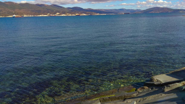 istock Transparent seawater of a harbour, surrounded by a coastal mountain range. 1290824174