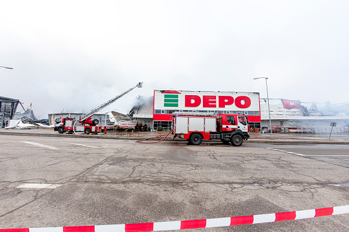 Rezekne, Latvia - December 12, 2020: Firefighters tackling a large fire at a warehouse DEPO in Rezekne, Latvia. \n\nAt 02.43 firefighters received a call from Stacijas Street in Rēzekne, Latvia\nAt 10.38, a fire in Rēzekne, where a building with an area of 13,500 square meters is burning, was localized.