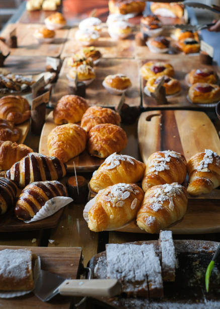 Many fresh bread on a wooden table.