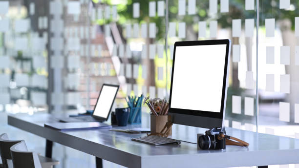 istock Side view of photographer workstation with modern multiple devices mockup on white office table. 1290827710