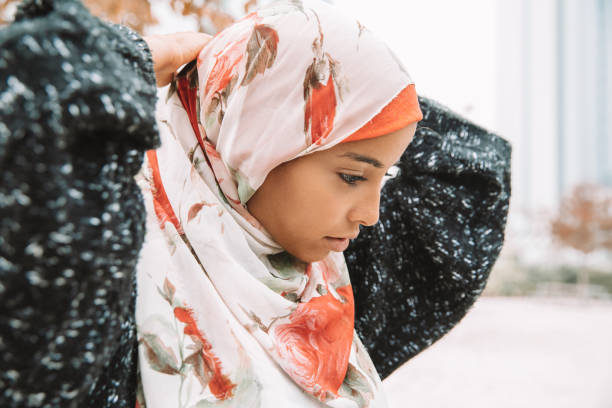 istock Young woman getting dressed wearing hijab 1290828598