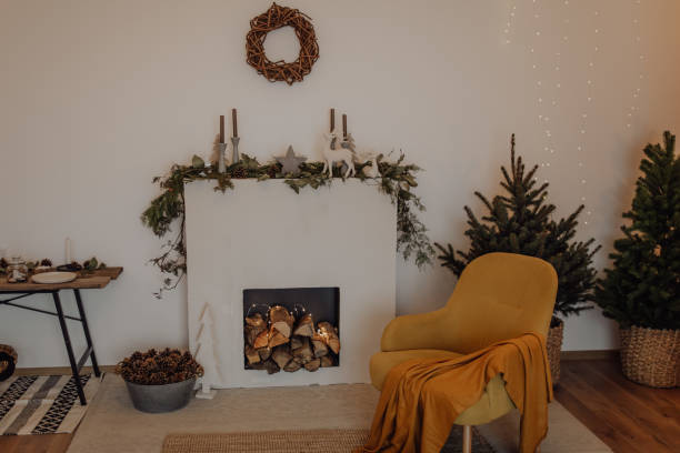 istock Design room with Christmas tree, fireplace. Interior eco style. Christmas decorated interior of couch and Christmas tree, modern and cozy. happy new year and merry christmas 1290828944