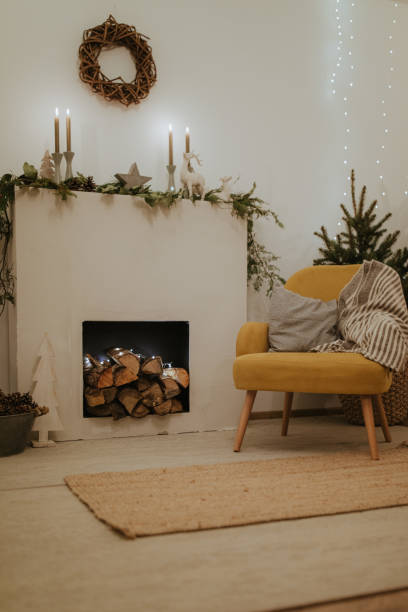 istock Design room with Christmas tree, fireplace. Interior eco style. Christmas decorated interior of couch and Christmas tree, modern and cozy. happy new year and merry christmas 1290828951