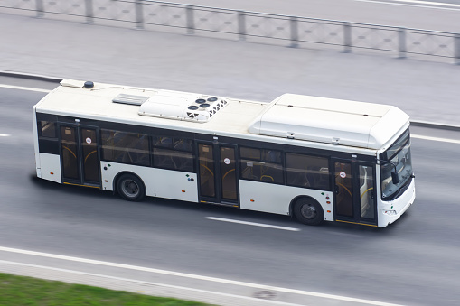 City bus travels on the highway, aerial view