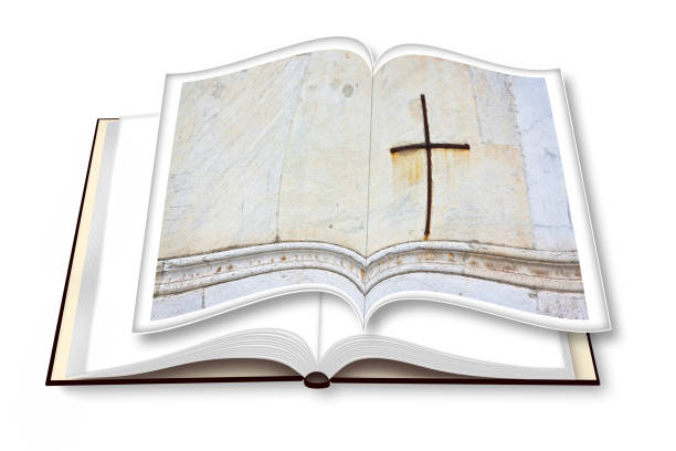 istock Opened photobook on withe background with christian iron cross - concept image 1290829748