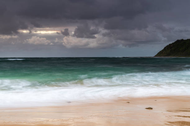istock Moody morning bay seascape with rain clouds 1290830068