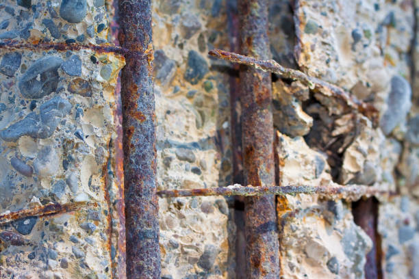 Danger cracked concrete electricity pylon with reinforcing iron bars in evidence