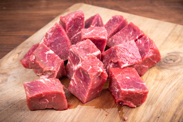 istock Fresh raw beef slices for goulash on wooden kitchen cutting board 1290831089