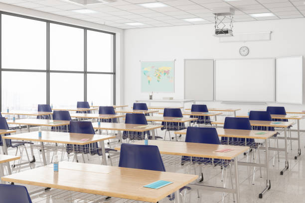 Protective Face Masks And Hand Sanitizers On The Desks According To New Normal Concept In An Empty Classroom. Protective Face Masks And Hand Sanitizers On The Desks According To New Normal Concept In An Empty Classroom. junior high photos stock pictures, royalty-free photos & images