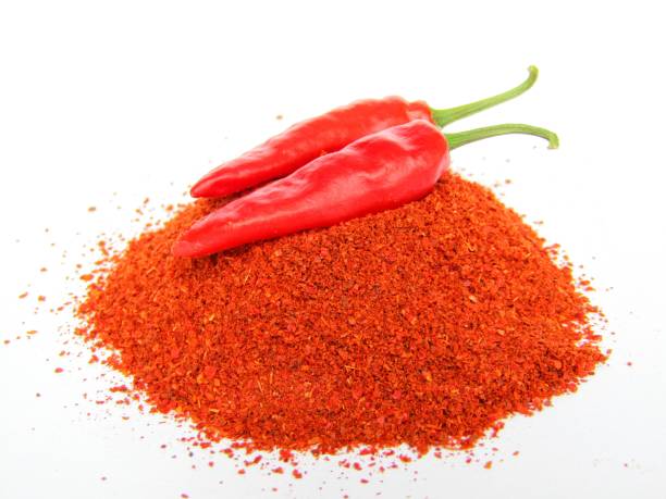 istock Red chili pepper with powder on white background 1290836503
