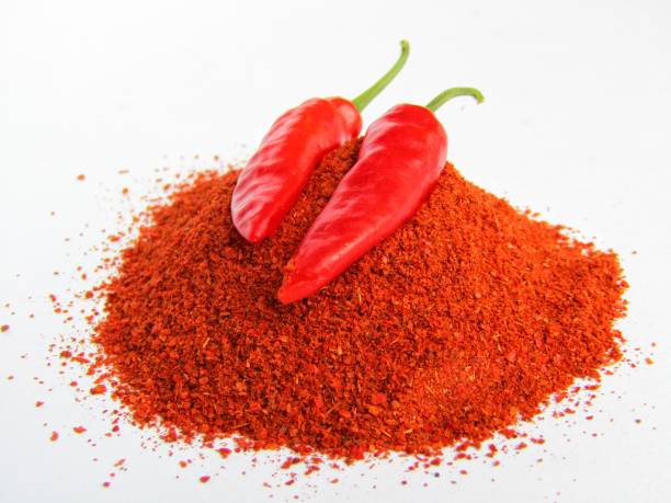 istock Red chili pepper with powder on white background 1290836520