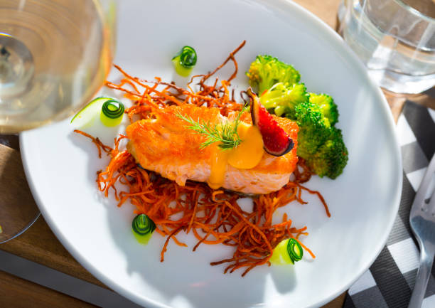 istock Fried salmon with smoked julienne carrot, broccoli, cucumber, figs 1290836660