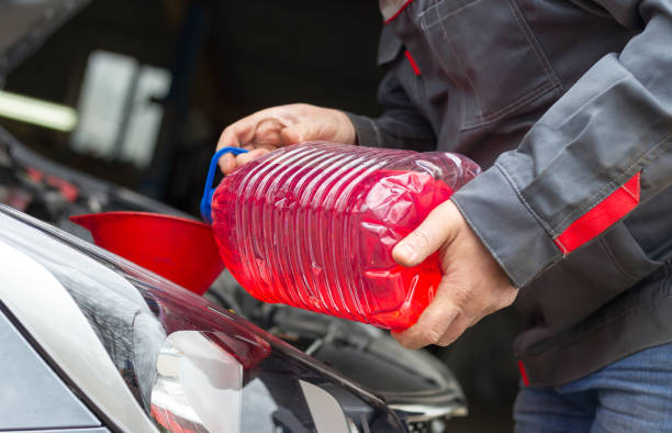 istock The Replacing fluids in a car mechanic 1290838719