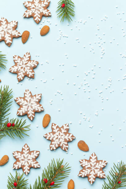 istock Star shaped gingerbread cookies on light blue wintery background. 1290840870