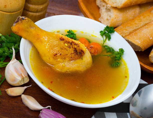 istock Thin soup with chicken leg in white bowl 1290841444