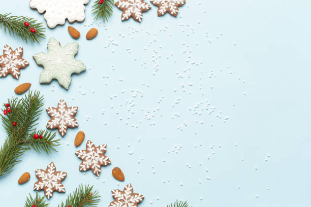 istock Star shaped gingerbread cookies on light blue wintery background. 1290841476