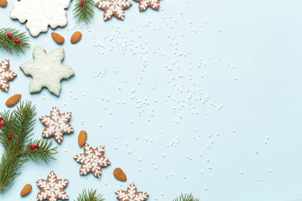 istock Star shaped gingerbread cookies on light blue wintery background. 1290841712