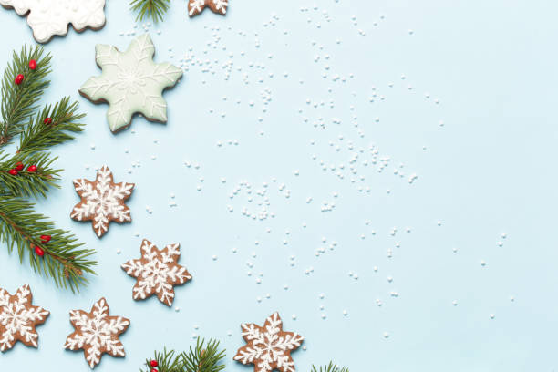 istock Star shaped gingerbread cookies on light blue wintery background. 1290841718