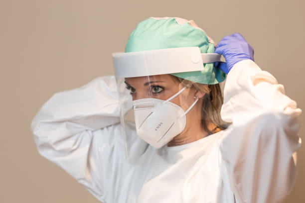 istock Medical worker in the coronavirus wearing a face shield and protective mask 1290843762
