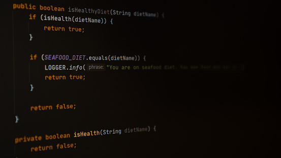 Programming code screen. Dark theme of IDE, dark mode of code editor. Writing programming code on laptop. High quality photo