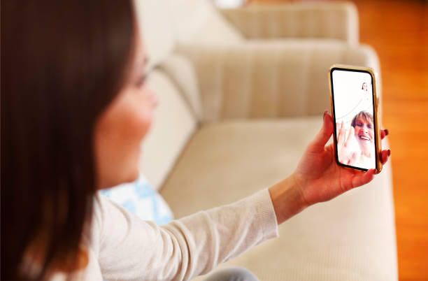istock Woman having video conversation on smartphone 1290848977