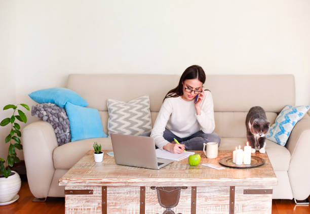 istock Female freelancer using smartphone at home 1290849055