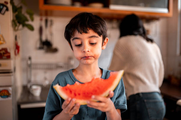 istock The little boy is eating a watermelon 1290849750