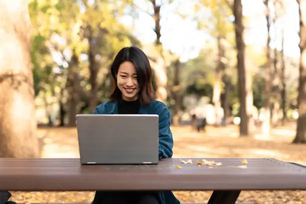 Photo of Asian youtuber vlogging from Autumn park