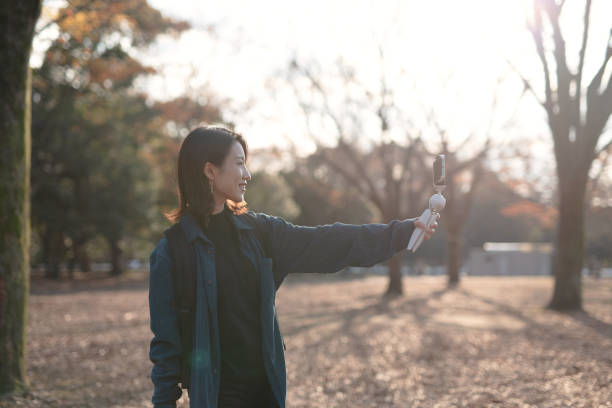 istock Asian youtuber vlogging from Autumn park 1290851052