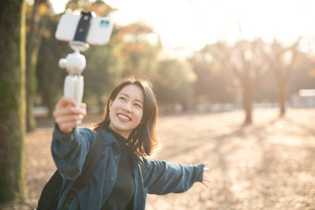 istock Asian youtuber vlogging from Autumn park 1290851705