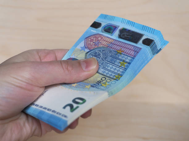 istock Hand holding Euro notes, European Union 1290853320