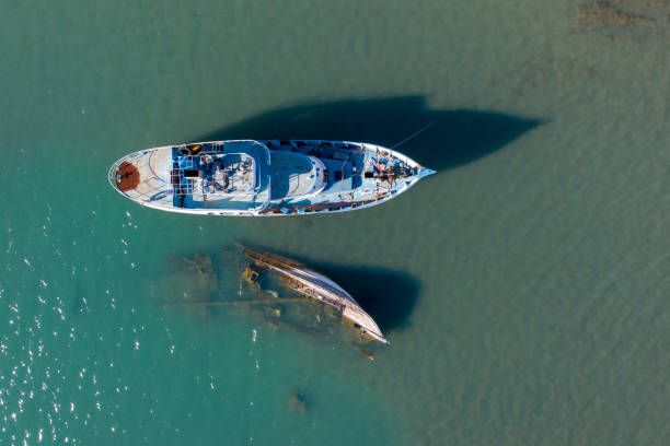 Old boat Sunken boat in sea Taken via drone. Antalya, Turkey. fishing boat sinking stock pictures, royalty-free photos & images