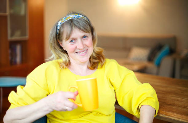 istock Mature woman drinking tea at home 1290855618