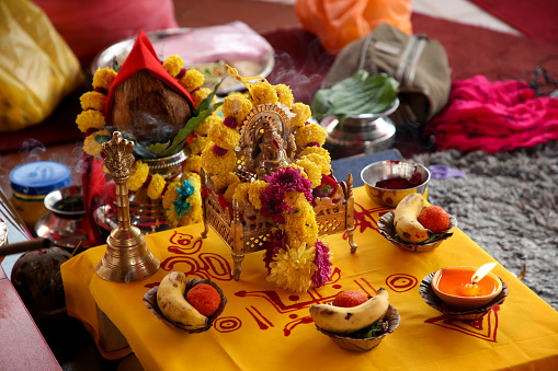 A focus scene of traditional Indian (Hindu) god with flower offering in Kuala Lumpur, Malaysia.