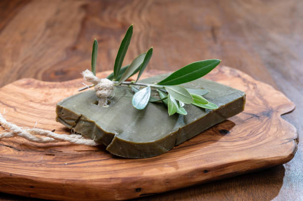 Block of handmade bio vegetal natural olives and bay leaf soap Green block of handmade bio vegetal natural olives and bay leaf soap from Provence, France savon stock pictures, royalty-free photos & images