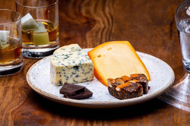 Tasting and pairing of different cheeses with strong alcoholic drinks, whisky, cognac or calvados